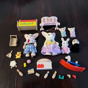 Sylvanian family rabbits and panda lot with toys.